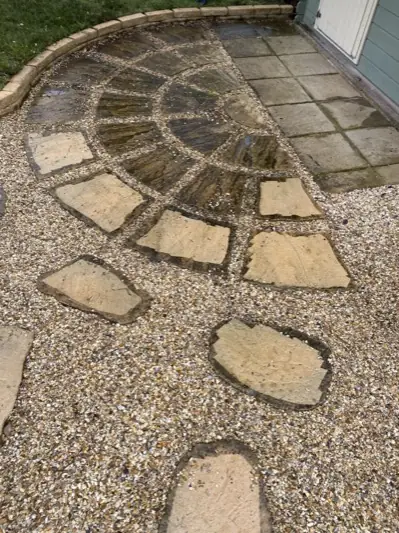 Sandstone patio circle darkened with dirt and algae