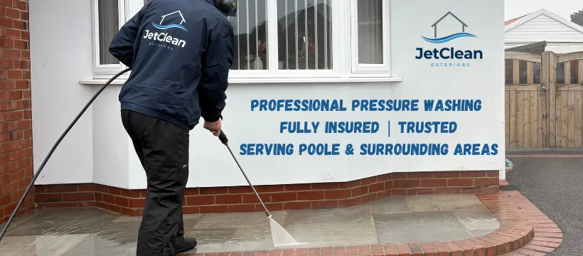 JetClean Exteriors pressure washing a sandstone patio. Text on the wall behind reads: Professional pressure washing, fully insured, trusted, serving Poole and surrounding areas.