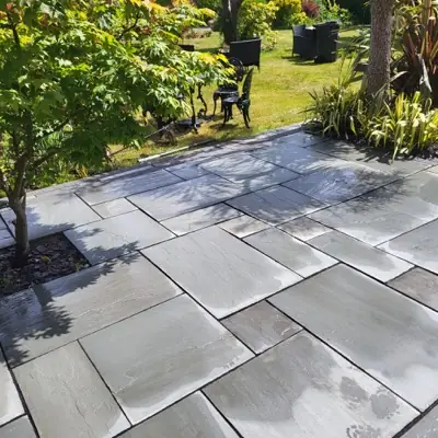 The same patio cleaned, stone tones showing again