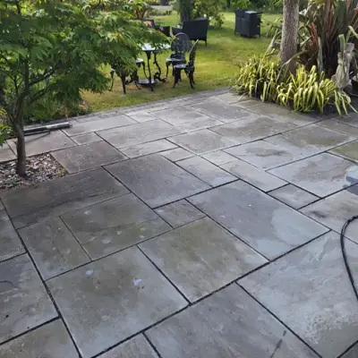 Grey sandstone patio dulled with algae